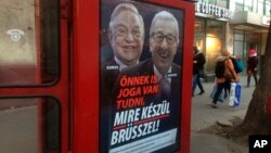 A phone box displays a billboards showing Hungarian-American financier George Soros and EU Commission President Jean-Claude Juncker above the caption “You have a right to know what Brussels is preparing to do!," on Vaci Avenue in Budapest, Hungary, Feb. 19, 2019.