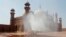 Volunteers disinfects the historical Badshahi Mosque ahead of the Muslim fasting month of Ramadan, in Lahore, Pakistan, April 22, 2020. 