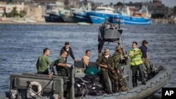An Egyptian coast guard dinghy brings bodies from a Europe-bound boat that capsized off Egypt’s Mediterranean coast, to the shore in Rosetta, Egypt, Sept. 22, 2016.