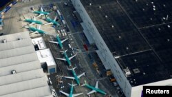 FILE - An aerial photo shows Boeing 737 Max airplanes parked on the tarmac at the Boeing factory in Renton, Wash., March 21, 2019.
