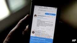 A man reads tweets on his mobile in New Delhi, India, Feb. 4, 2021. 