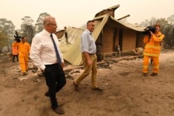 Australian Prime Minister Scott Morrison, front left, and Darren Chester MP tour the Wildflower farm owned by Paul and Melissa Churchman in Sarsfield, Victoria, Jan. 3, 2020.