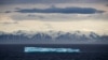 FILE - An iceberg floats past Bylot Island in the Canadian Arctic Archipelago, July 24, 2017.