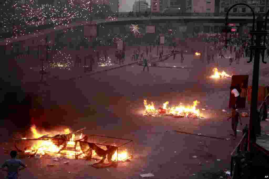Pro-military crowds and supporters of the former president Mohamed Morsi pelt each other with rocks, fireworks and firebombs in street battles near Ramsis Square, Cairo, Oct. 6, 2013.