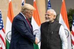 FILE - President Donald Trump and Indian Prime Minister Narendra Modi shake hands before their meeting at Hyderabad House, in New Delhi, India, Feb. 25, 2020.