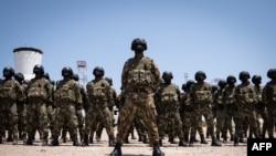 Mozambican soldiers stand as Mozambican President Filipe Nyusi and Rwanda President Paul Kagame review the troops on Sept. 24, 2021, in Pemba, Cabo Delgado province, Mozambique.