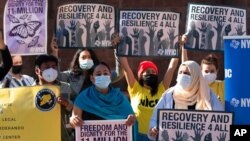 FILE - Demonstrators with the New York Immigration Coalition rally asking President-elect Joe Biden to prioritize immigration reform, Nov. 9, 2020, in New York. 
