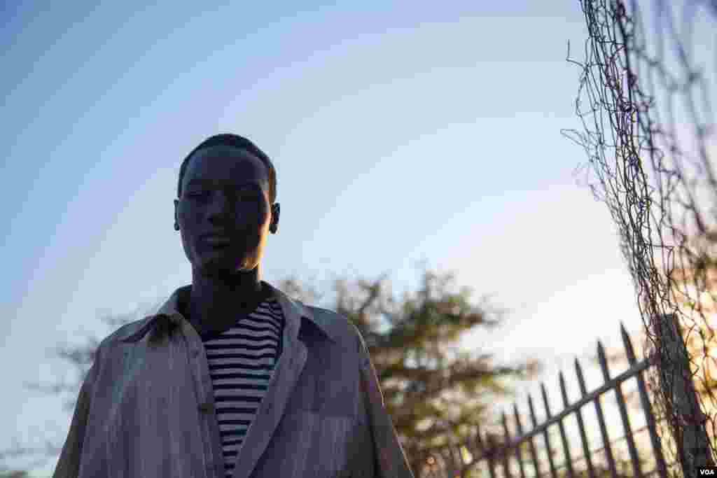 A young boy stands outside the gate of Mother of mercy hospital. Nuba Mountains. (Adam Bailes/VOA News)
