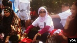 Bangladeshi-born Farzana Morshed of the Queens Community House sits in the shade on the edge of the "All in for Citizenship" rally at the U.S. Capitol in Washington, DC, Wednesday, April 10, 2013. (Photo by Kate Woodsome)