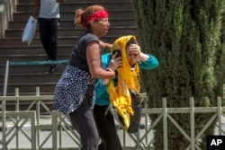 Family members of victims react at Addis Ababa international airport Sunday, March 10, 2019.