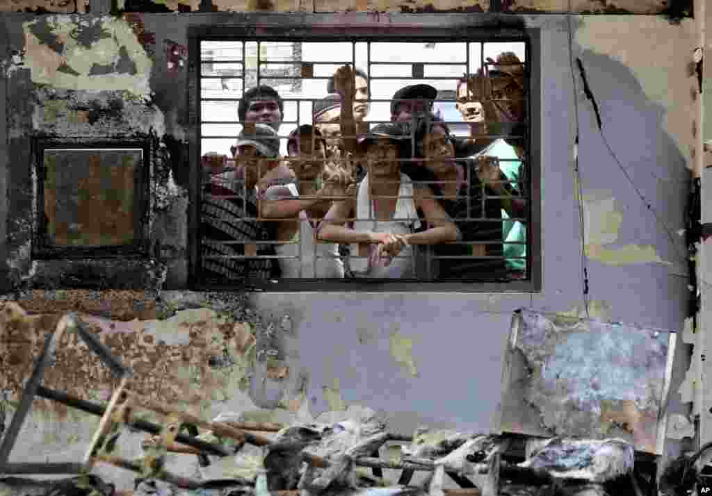 Inmates set fires and started a deadly riot that left five people dead and hundreds of prisoners on the loose, including convicted terrorists.