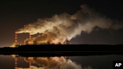 FILE - Plumes of smoke rise from Europe's largest lignite power plant in Belchatow, central Poland, Nov. 28, 2018.