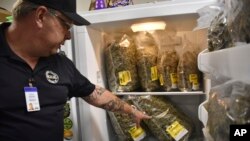 Montana Advanced Caregivers owner Richard Abromeit talks about different strains of marijuana stored in a refrigerator at the Billings, Mont., medical marijuana dispensary on Nov. 11, 2020. (AP Photo/Matthew Brown)