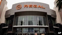 FILE - Two shoppers walk past a Regal movie theater in Irvine, Calif., on Sept. 8, 2020. Warner Bros. said on Oct. 5, 2020 that its sci-fi pic “Dune” will now open in October 2021, instead of this December. 