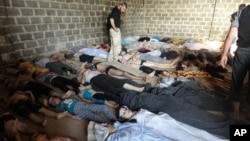 FILE - A photo taken on August 22, 2013, purports to show some of the estimated 1,000 victims of a suspected chemical weapons attack in the Damascus suburb of East Ghouta, Syria.