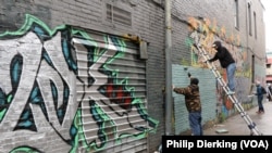 Members of Art Bloc DC and 2DK work on a graffiti mural in U Street.