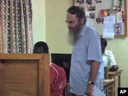 Reverend Chris Jenkins, education coordinator for the Jesuit Refugee Service's Kakuma Camp education program, works with a student, Aug 2010