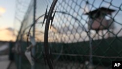FILE - The sun rises over the Guantanamo detention facility at the Guantanamo Bay U.S. Naval Base, Cuba, May 13, 2009.
