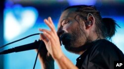 Thom York, lead singer of English rock band Radiohead, performs during their concert at the Optimus Alive music festival in Lisbon, Sunday, July 15 2012. (AP Photo/Armando Franca) 