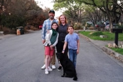 FILE The Morgan family, who relocated from San Francisco so the children could attend school in-person, pose for a portrait near their rental house in Austin, Texas, U.S., March 14, 2021. Picture taken March 14, 2021.