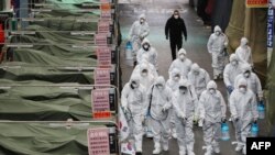 Market workers wearing protective gear spray disinfectant at a market in the southeastern city of Daegu on February 23, 2020 as a preventive measure after the COVID-19 coronavirus outbreak.