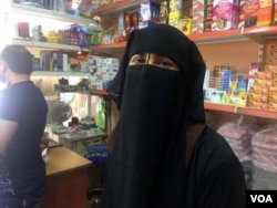 Safana, 29, still wears a veil despite the ban, removing it only at military checkpoints, in Mosul, Iraq, June 8, 2017. (H. Murdock/VOA)