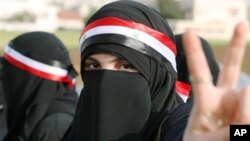 A Syrian protester flashes the victory sign during a protest calling for President Bashar Assad to step down in front of the Syrian embassy in Amman, Jordan, Sunday, April 17, 2011.