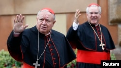 Mexican Cardinals Juan Sandoval Iniguez (L) and Josz Francisco Robles Ortega (R) wave as they arrive at a meeting at the Synod Hall in the Vatican March 7, 2013.