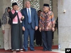 U.S. Vice President Mike Pence, center, is given a tour during his visit to the largest mosque in Southeast Asia, in Jakarta.