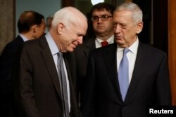 FILE - Committee chairman U.S. Senator John McCain, left, welcomes retired U.S. Marine Corps General James Mattis to testify before a Senate Armed Services Committee hearing on his nomination to serve as defense secretary in Washington, Jan. 12, 2017.