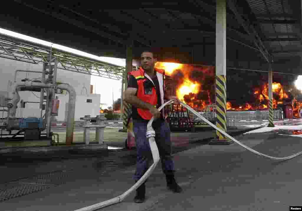 A Palestinian firefighter at Gaza&#39;s main power plant, which was hit in Israeli shelling, in the central Gaza Strip, July 29, 2014.