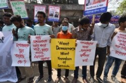 FILE - Activists hold placards during a demonstration demanding the repeal of the Digital Security Act, in Dhaka, Feb. 27, 2021, following the death of writer Mushtaq Ahmed in jail months after his arrest.