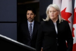 Canada's Prime Minister Justin Trudeau arrives to a news conference, with Deputy Minister of National Defence Jody Thomas, in Ottawa, Ontario, Canada, Jan. 11, 2020.