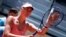 FILE - Russian tennis player Maria Sharapova touches her racket at the end of her match against Colombian Mariana Duque Marino in Madrid, May 5, 2015. 