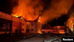 Firefighters work at a site of a Russian drone strike, near Bila Tserkva, Kyiv region, Ukraine, in this handout picture released Jan. 30, 2024. (Press Service of the National Police of Ukraine/Handout via Reuters)