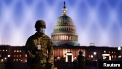 Members of the National Guard gather at the U.S. Capitol as the House of Representatives prepares to begin the voting process on a resolution demanding U.S. Vice President Pence and the cabinet remove President Trump from office, in Washington, U.S., Janu