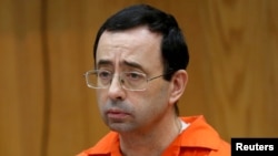 FILE - Larry Nassar, a former team USA Gymnastics doctor who pleaded guilty in November 2017 to sexual assault, listens to victims impact statements during his sentencing in the Eaton County Circuit Court in Charlotte, Mich., Jan. 31, 2018. 