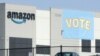 FILE - In this Tuesday, March 30, 2021 file photo, a banner encouraging workers to vote in labor balloting is shown at an Amazon warehouse in Bessemer, Ala. Amazon workers voted against forming a union, Friday, April 9, in Alabama, handing the…