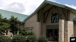 A person enters the Shenandoah Valley Juvenile Center, June 20, 2018, in Staunton, Va. Immigrant children as young as 14 housed at the juvenile detention center say they were abused and their claims are detailed in federal court filings that include a half-dozen sworn statements from Latino teens jailed there for months or years. 