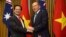 Vietnamese Prime Minister Nguyen Tan Dung and his Australian counterpart Tony Abbott shake hands before witnessing the signing of a "friendship agreement" between their countries at Parliament House in Canberra, Australia, March 18, 2015.