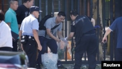 Police work at the scene of explosion after the blast outside the U.S. embassy in Beijing, China, July 26, 2018.