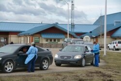 Nurses interview patients through their car windows after providing them with COVID-19 vaccines at the Piegan-Carway border crossing after they drove from Canada to Montana to receive excess doses from the Blackfeet tribe, near Babb, Mont, April 29, 2021.