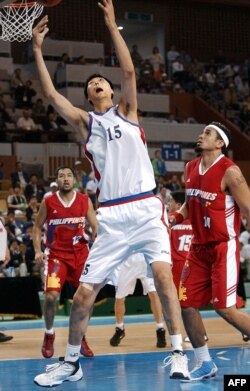 North Korean basketball player Ri Myoung-Hun competes at the 14th Asian Games in Busan, South Korea in Sept. 2002.