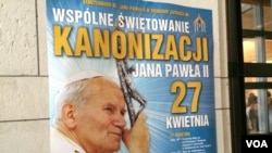 Posters all around town say “Communal Celebration of the canonization of John Paul II, April 27,” Cracow, Poland, April 22, 2014. (Jerome Socolovsky/VOA)