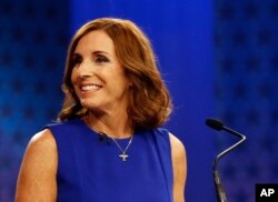 U.S. Rep. Martha McSally, R-Ariz., goes over the rules in a television studio prior to a televised debate with U.S. Rep. Kyrsten Sinema, D-Ariz., Oct. 15, 2018, in Phoenix.