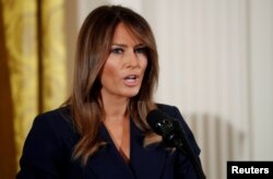 FILE - First lady Melania Trump participates in a celebration of military mothers and spouses at the White House in Washington, May 9, 2018.