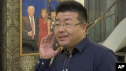 Ding Chenling, a technology investor and well-known tech blogger on Weibo, is interviewed by the Associated Press, Oct. 30, 2017, about President Donald Trump's visit to Asia in Beijing, China.