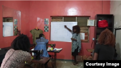 Hussena Raji, a fashion designer in Kaduna, teaching her employees about hip-hop fashion