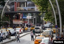 FILE - Taxi drivers wait for costumers in Kizilay Square, in Ankara, Turkey, June 17, 2013.
