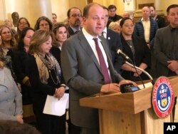 FILE - Colorado Gov. Jared Polis speaks at a news conference in Denver, Feb. 28, 2019.